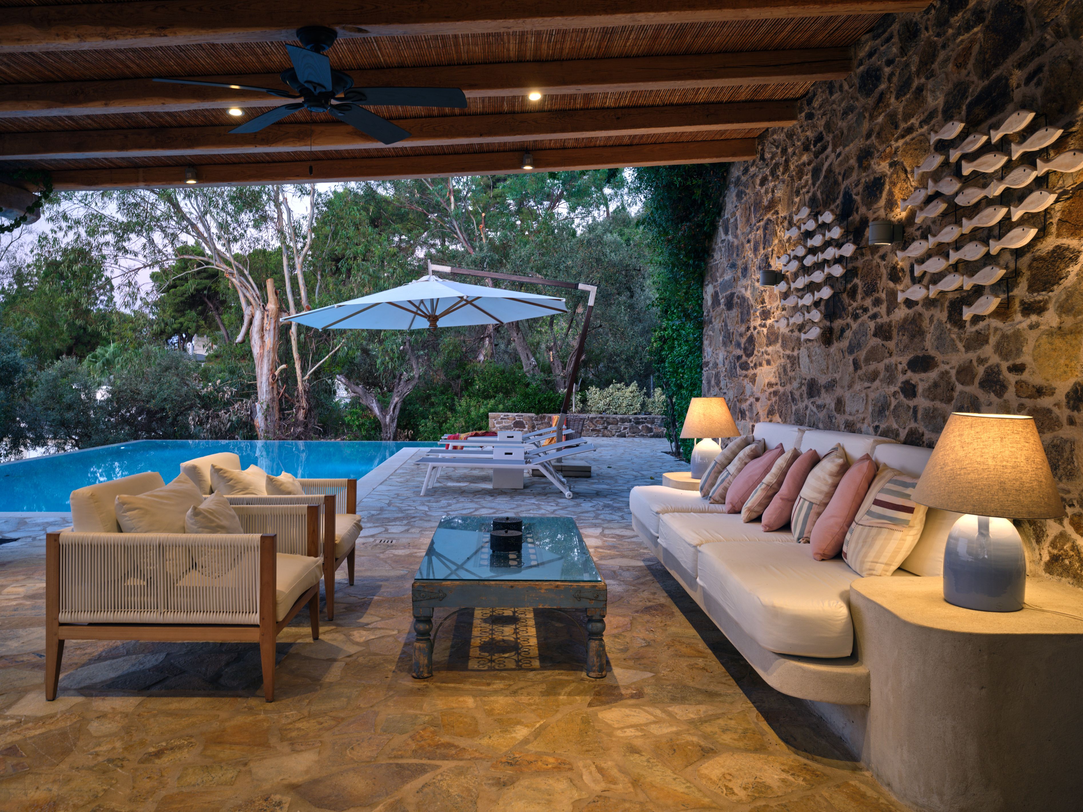The covered outdoor lounge beside the pool