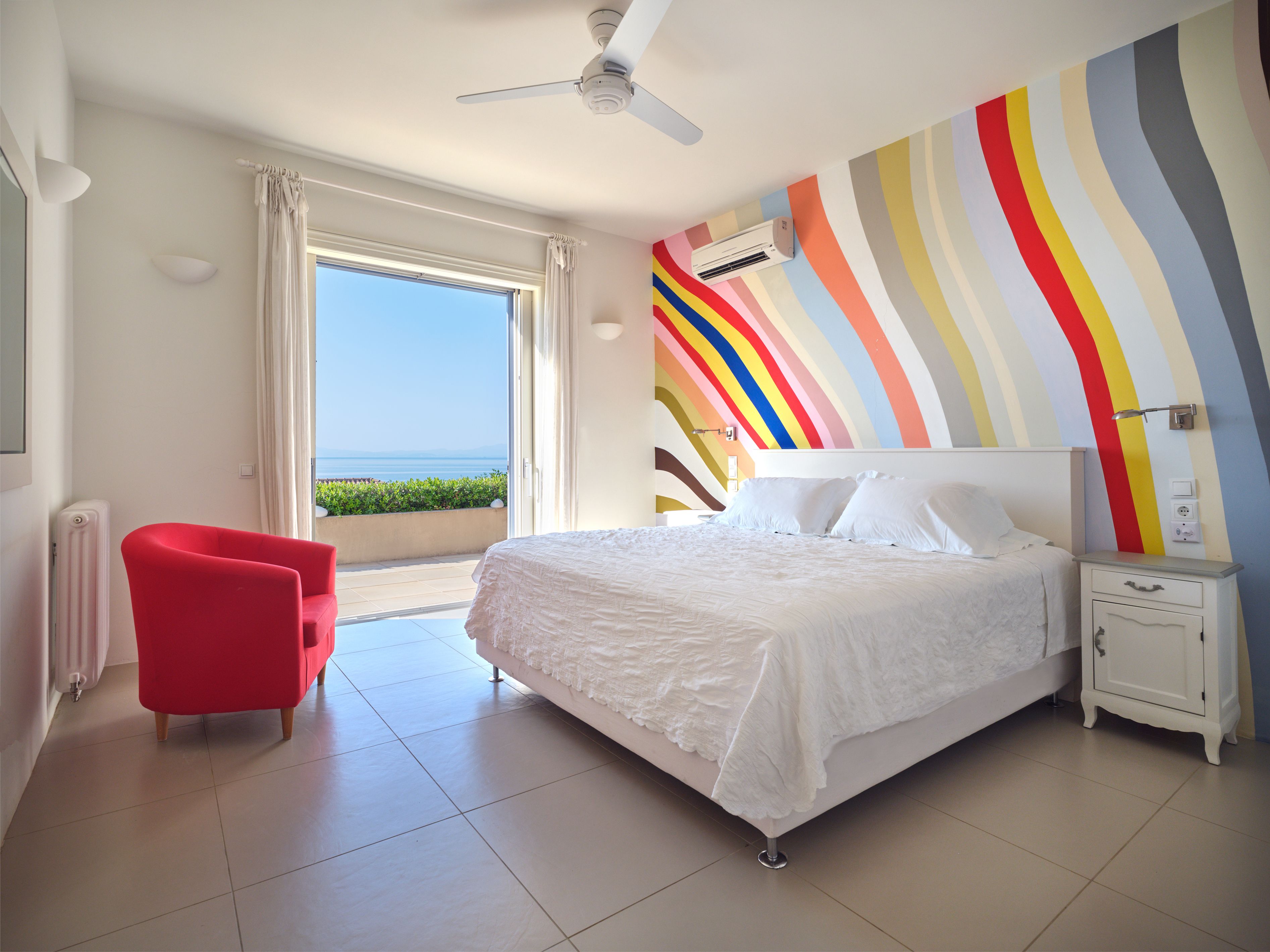 The master bedroom with its rainbow-striped wall