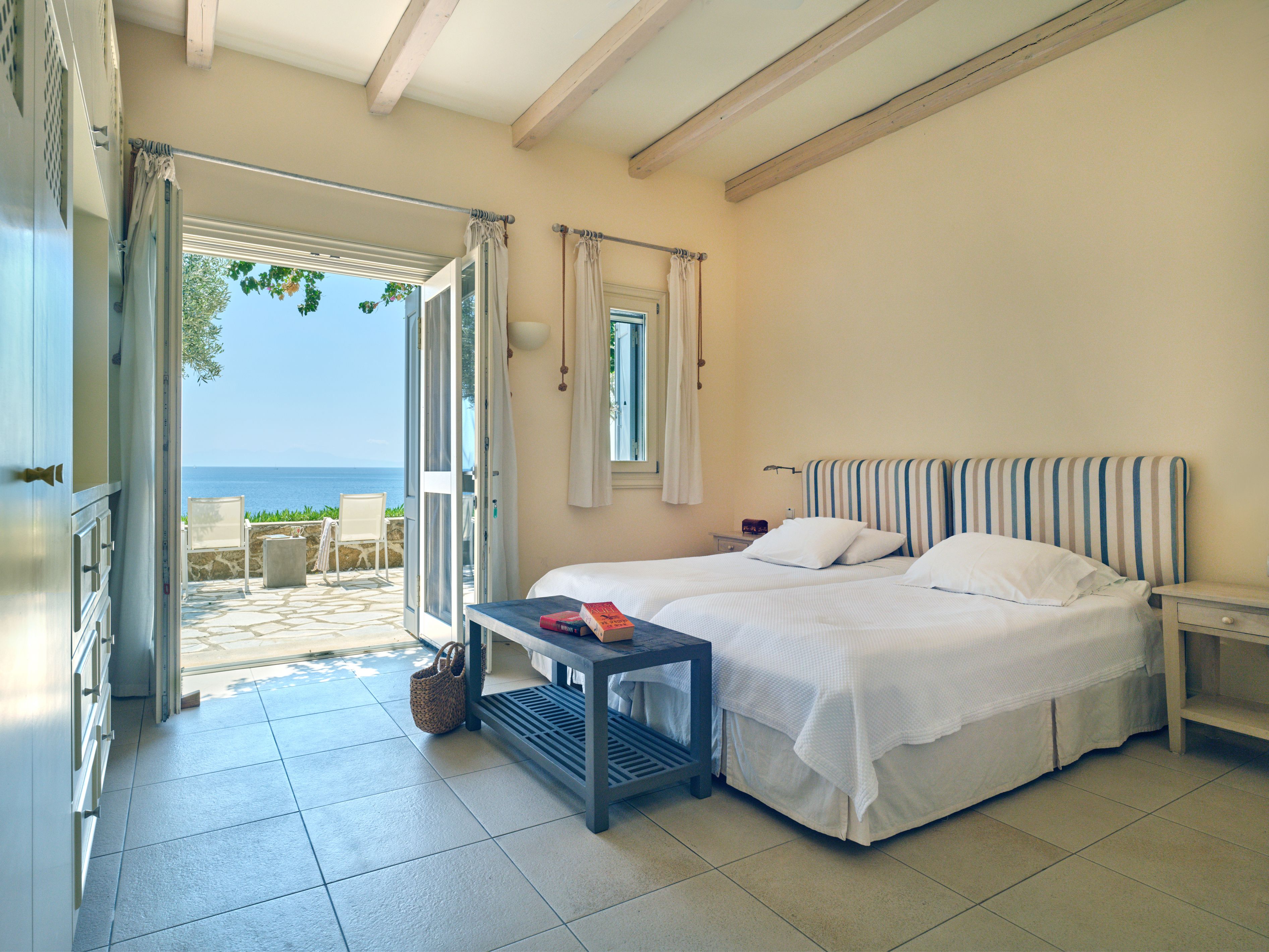 A ground-floor ensuite bedroom with doors to the sea view