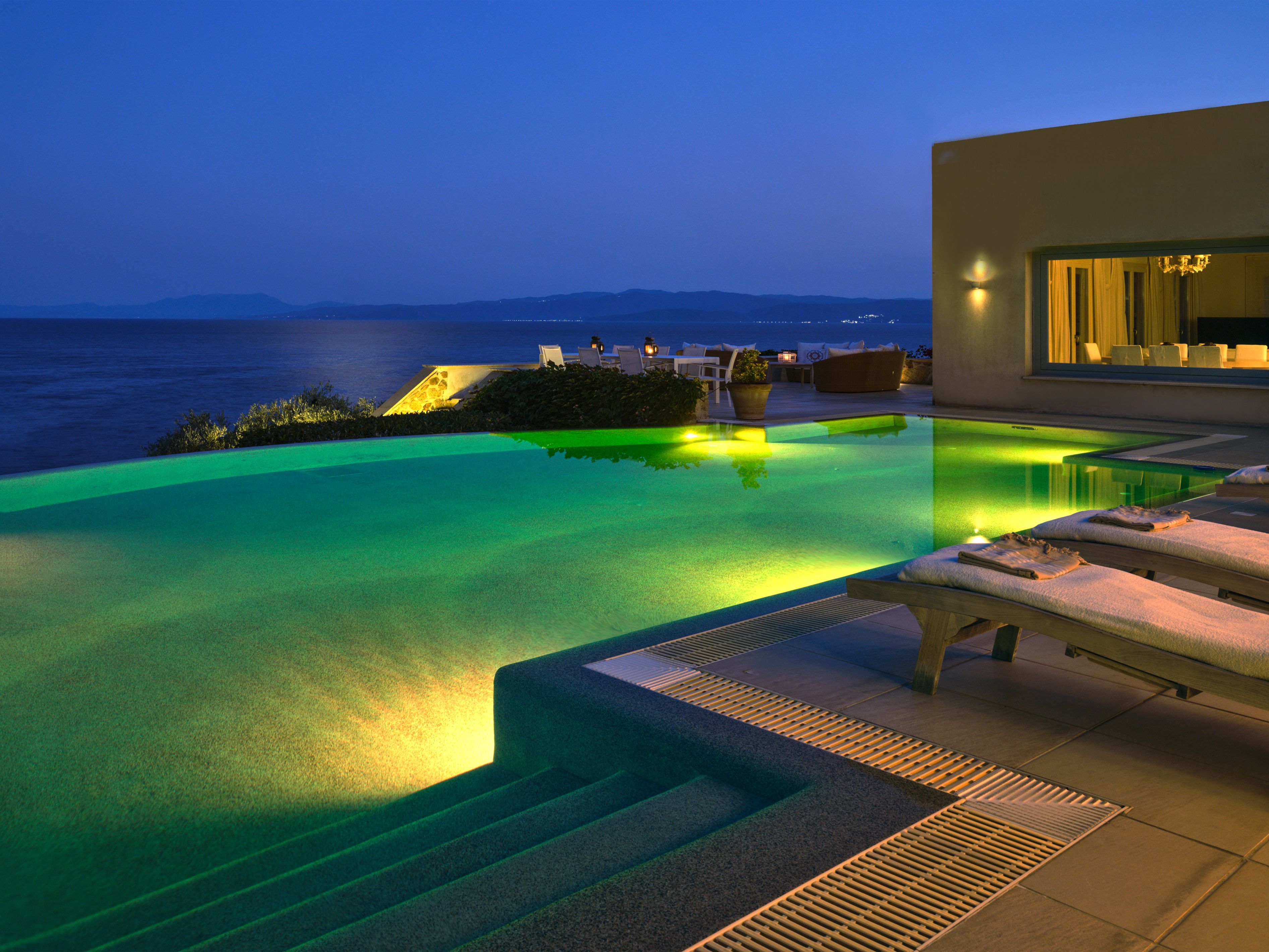 The infinity pool lit up at dusk