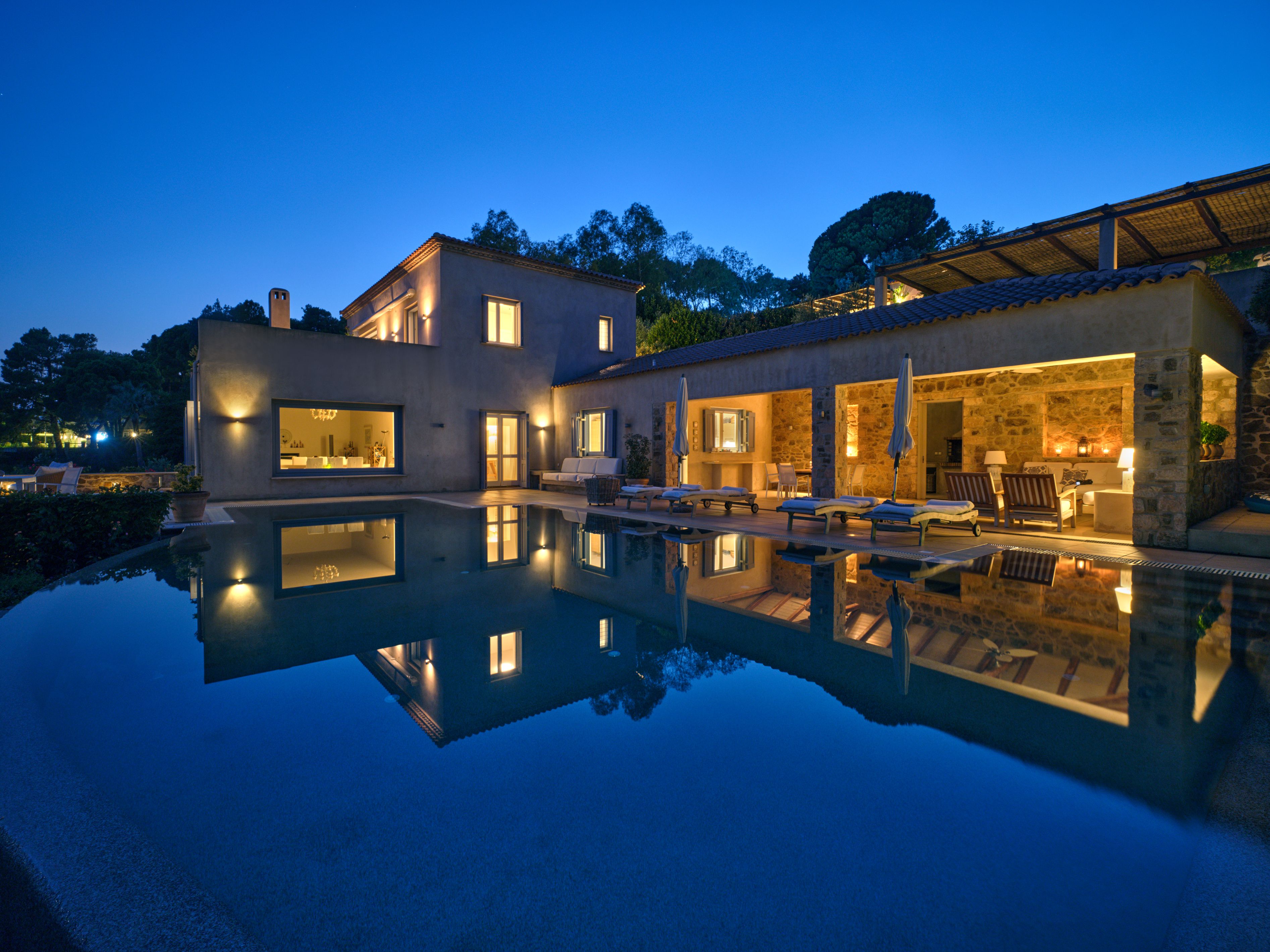 Villa Goldie and the pool lit up after sunset
