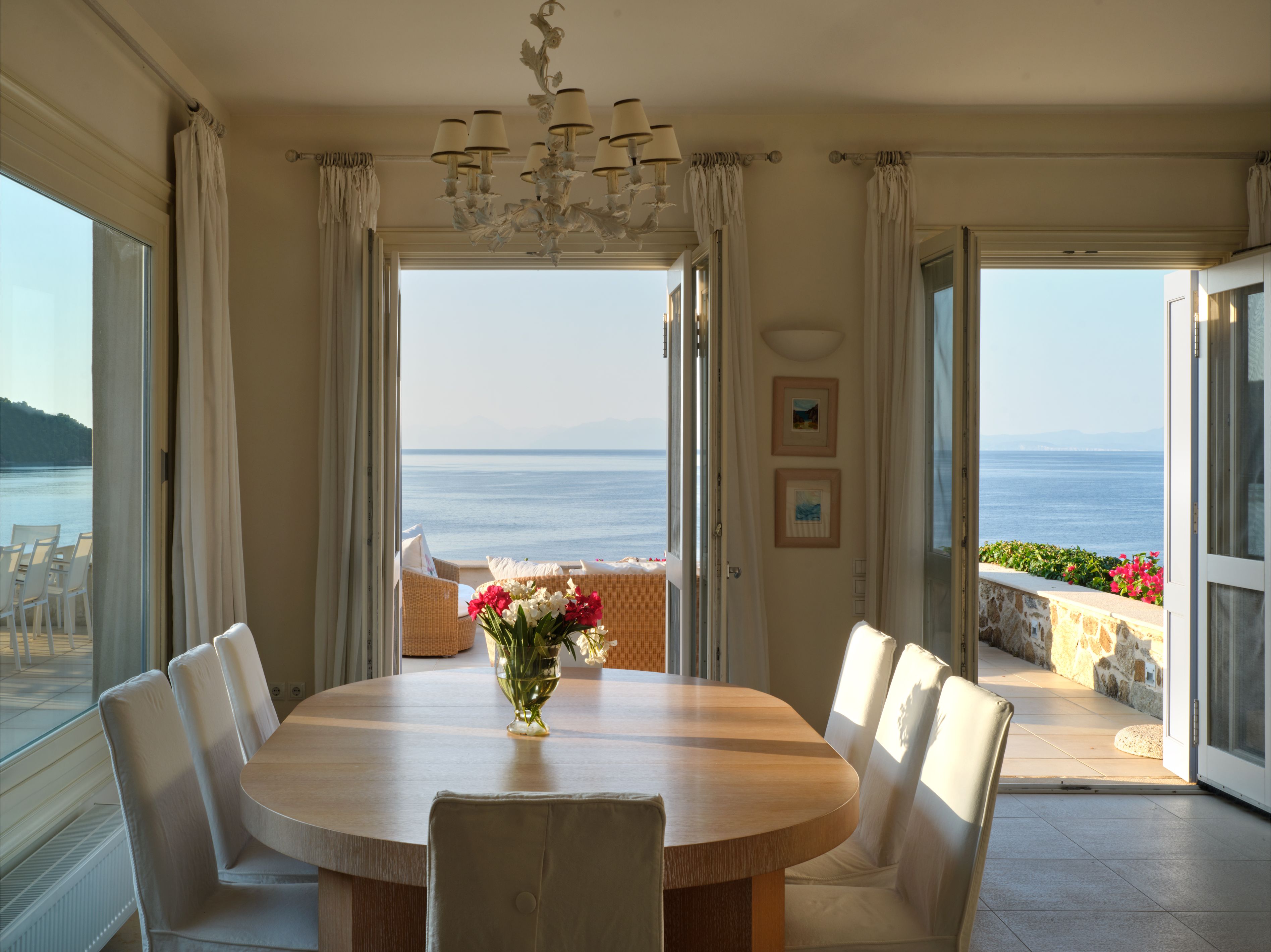 The dining table with doors open to the sea view
