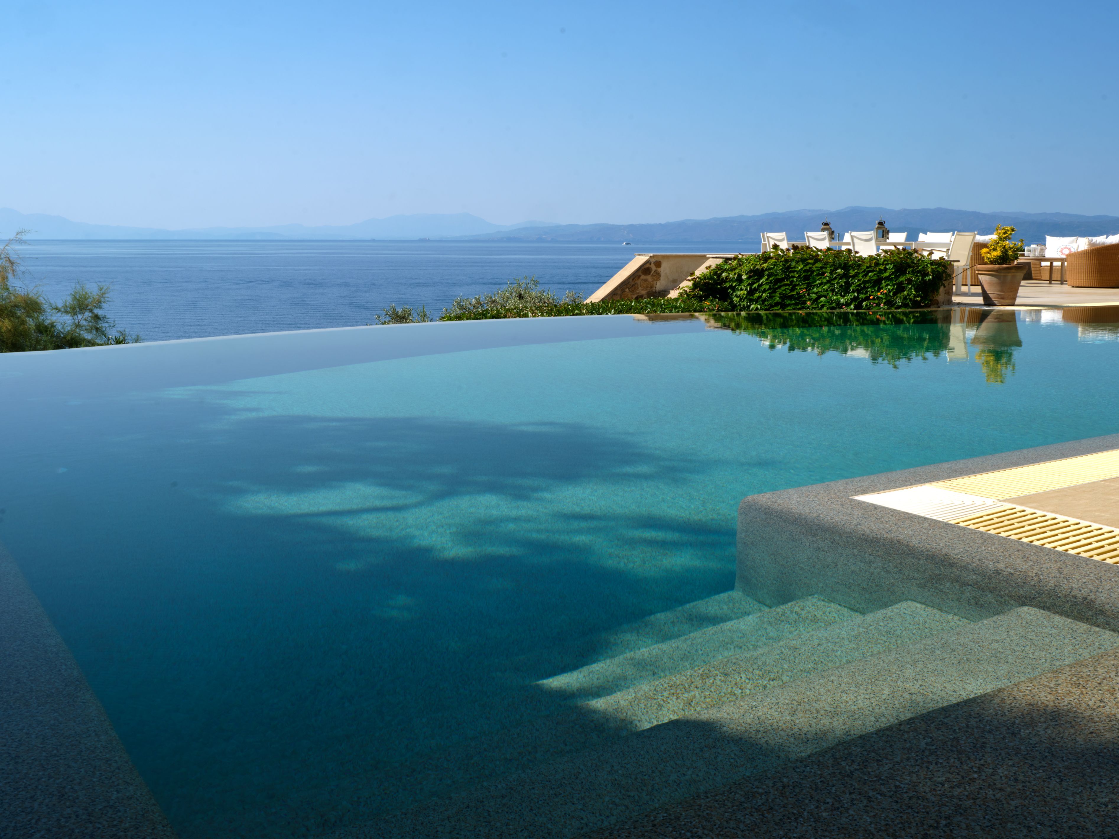 The infinity edge of the pool meeting the sea