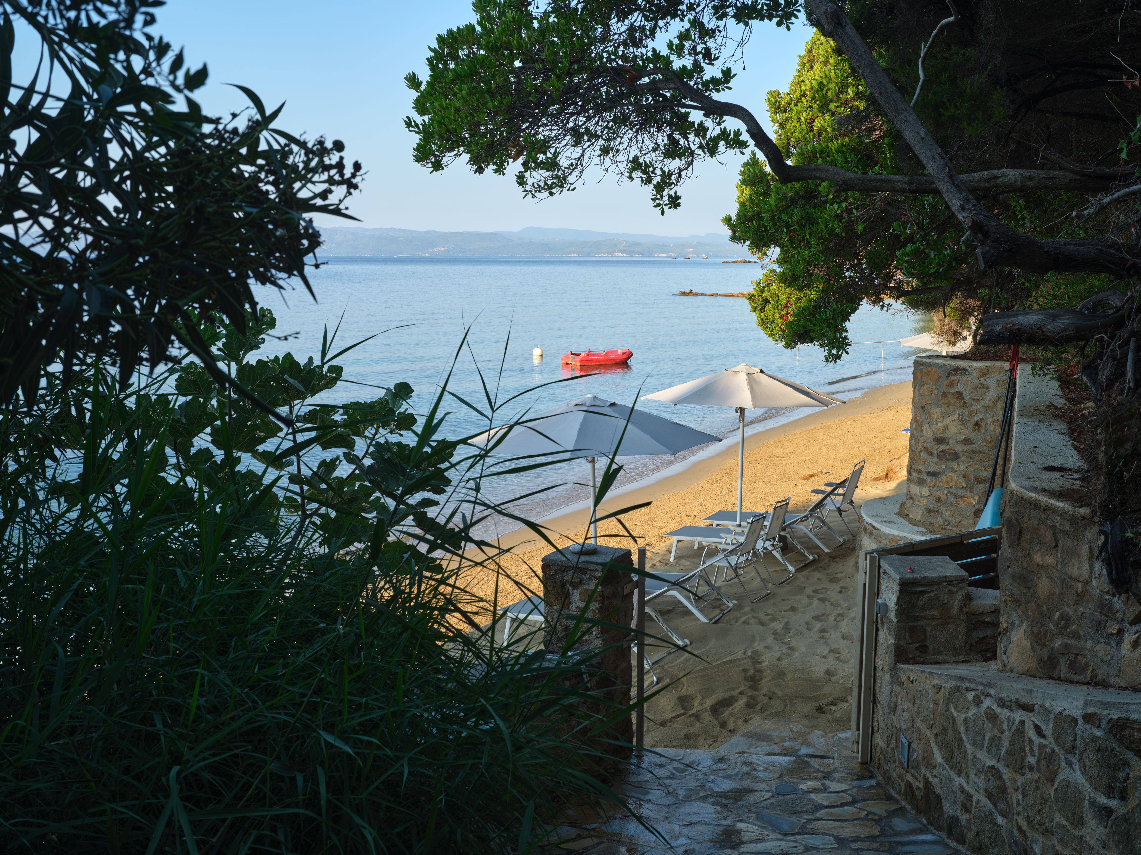 Stone steps at the end of the estate path, opening onto the beach